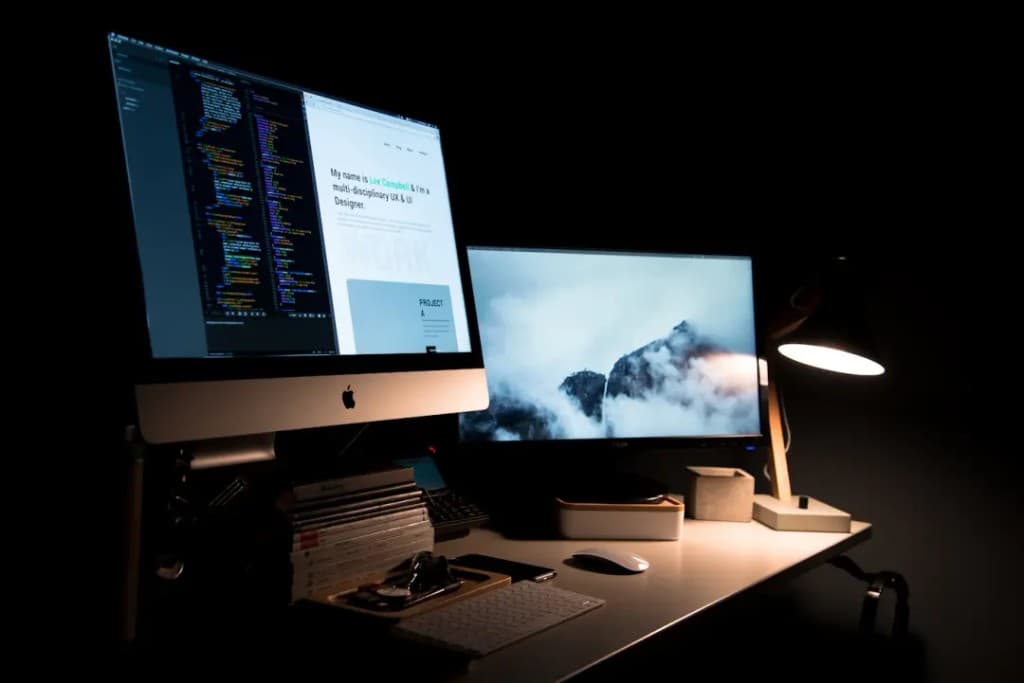 Developer workspace with dual monitors and UI design